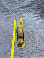 Top view showing Stanley lever cap and overall length beside tape measure