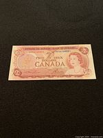 Obverse of 1974 Canadian $2 bill showing Queen Elizabeth II portrait and serial AB561468351