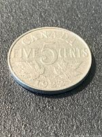 Reverse of 1922 Canada five-cent coin showing date and Near S position