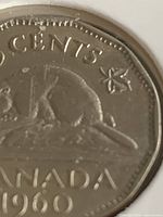 Reverse of 1960 Canadian 5-cent coin showing beaver design and partial details