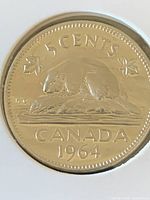 Reverse side of 1964 Canada five-cent coin in holder
