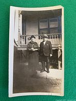 Full view of photograph showing couple and house background