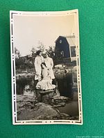 Front of vintage snapshot showing three women, border visible, tear on right edge