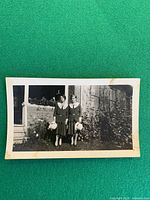 Entire photograph front showing two women in period dress and surroundings