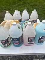 Front view of multiple gallon jugs and pads