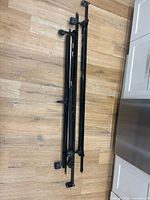 All disassembled frame rails, casters attached, black steel