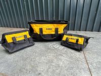Three DeWalt tool bags arranged side by side showing relative sizes and overall condition