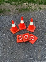 Three cones standing, three folded on gravel surface