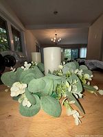 White pillar candles visible with decorative greenery (greenery not included)