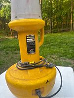 Close view of base with label and wrapped power cord