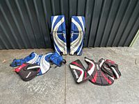 Full set laid out showing leg pads, chest protector, blocker, catcher