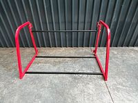 Overall view of red and black steel tire rack