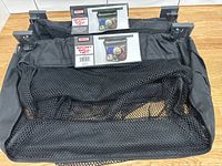 Two black mesh wall-mount sport ball nets with brackets and packaging visible