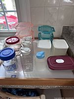 Tray displaying full assortment of plastic containers, bottles, canisters and glass jar