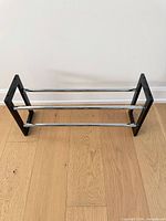 Shoe rack at minimum width showing two chrome tiers and black ends