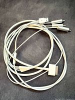 Full view of Apple 30-pin composite AV cable showing 30-pin dock end, USB-A, and RCA plugs