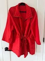 Full view of red jacket on hanger
