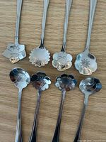 Close-up of spoon bowls showing eight distinct floral shapes