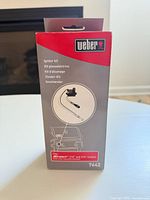 Front of sealed box showing Weber igniter kit model 7642 graphics and compatibility