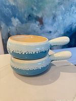 Side view of both bowls stacked showing exterior glaze and handles