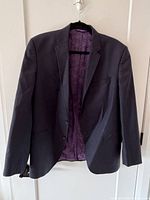 Front view of dark navy Ted Baker blazer on hanger
