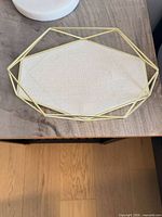 Top view of geometric metal frame tray with fabric insert