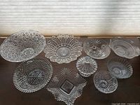 Group shot of all nine clear glass bowls laid out on tabletop
