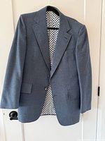 Front view of blue Hardy Amies blazer on hanger