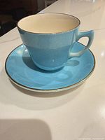 blue Wade teacup on matching saucer showing color and gold rim