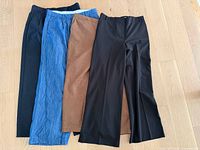 Four pairs of women’s pants laid out side by side