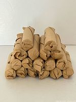 Stacked bundle of 17 sealed paper coin rolls
