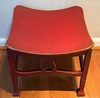 Top view showing concave red painted seat and edge wear