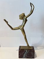 Full view of bronze dancer on marble base