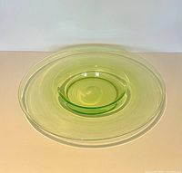 Top view of green glass platter and bowl nested