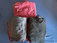 Stack of folded men’s shirts displaying variety of colours and fabrics