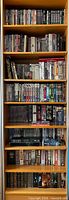 Full bookshelf view showing seven shelves filled with DVD and Blu-ray cases