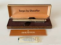 Open presentation box showing pen, booklet and cartridge pack
