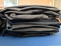 Stack of folded dark coloured pants