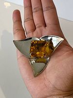 Front view of sterling silver leaf brooch showing topaz-coloured glass stone