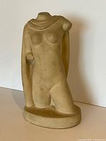 Front view of plaster nude torso sculpture