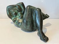 Full view of bronze reclining female nude sculpture