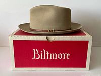 Side view of tan fedora resting on red Biltmore box