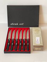 Boxed set of six steak knives beside King Deluxe waterstone