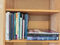 Books on shelf showing art, craft and gardening titles plus four horizontally stacked art books