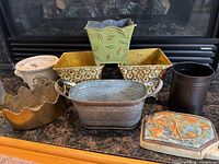 All eight planters arranged showing shapes and materials