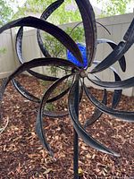 Close view of spinner blades and blue orb showing material and wear