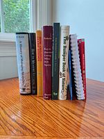 Spine view of all eight books standing upright