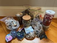 Wide shot of all containers of stones, gems and agate slices
