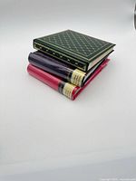 Stack of three new photo albums showing colors and shrink bands