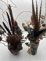 Front view of both ceramic vases with dried arrangements